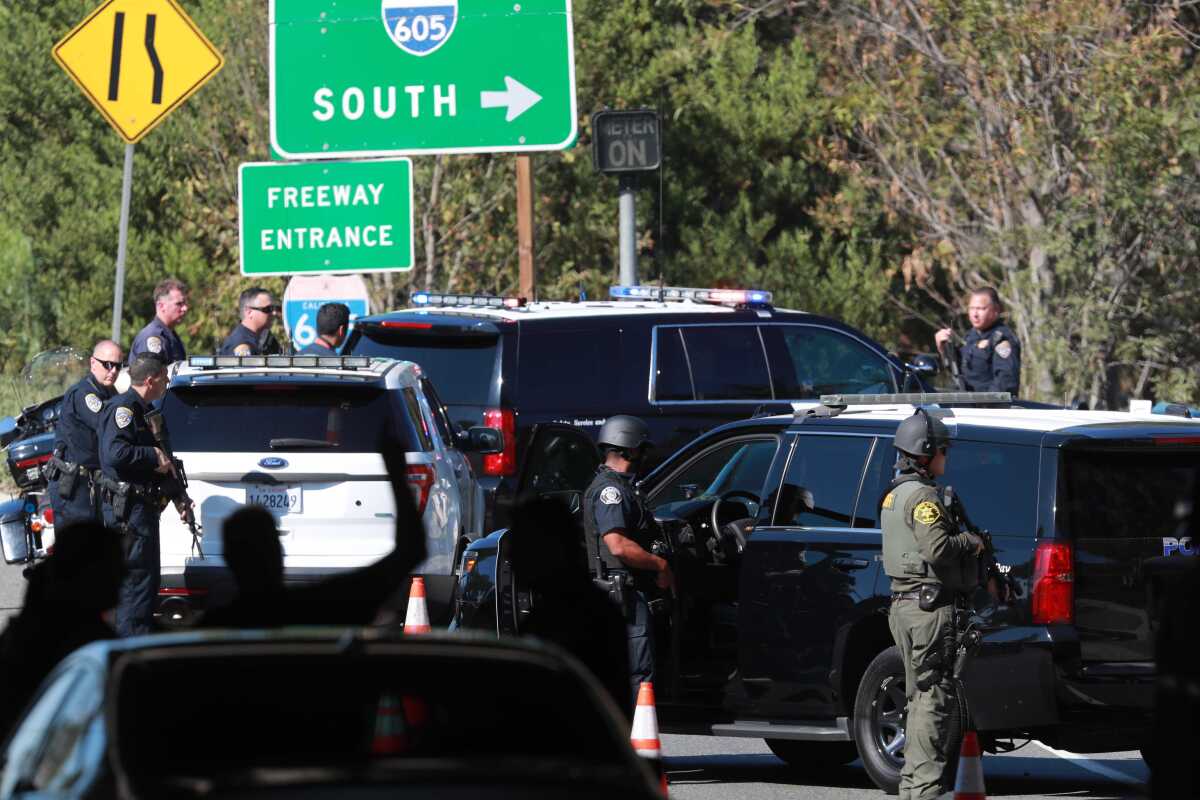 Law enforcement personnel stage near the Katella Avenue onramp to the 605 Freeway in Los Alamitos.