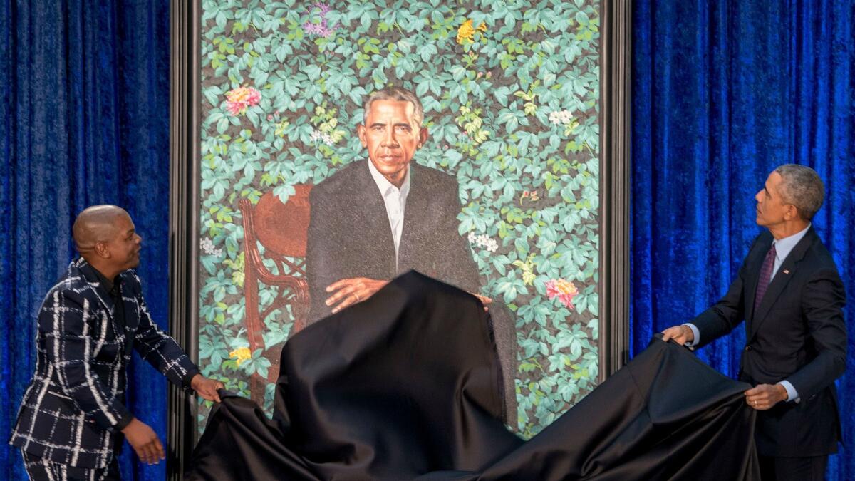 Former President Barack Obama and Artist Kehinde Wiley unveil Obama's official portrait at the Smithsonian's National Portrait Gallery on Monday in Washington.