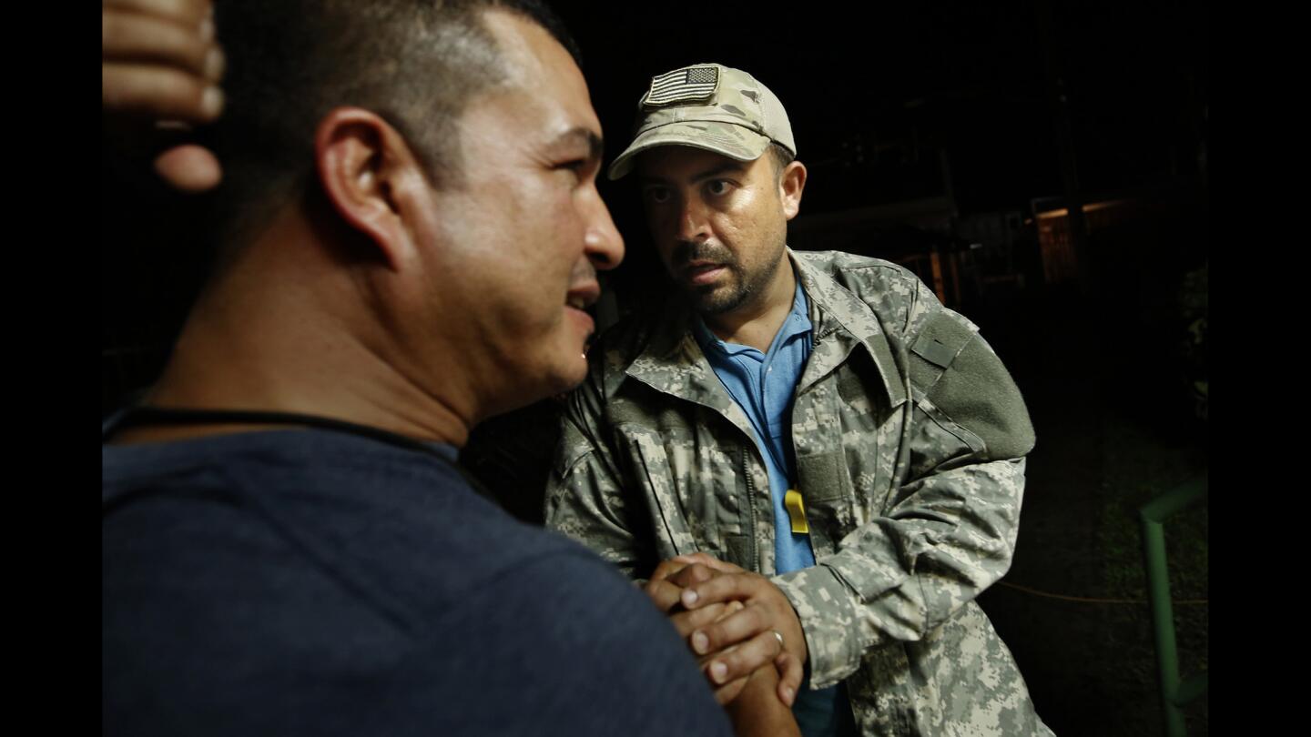 The mayor of Utuado, Ernesto Irizarry Salvá, right, comforts a man who stopped at a local command center. Like many, the politician lost everything in the hurricane, but he is trying to help residents.