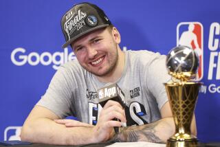 Mavericks guard Luka Doncic smiles during a news conference after the team's win over the Timberwolves