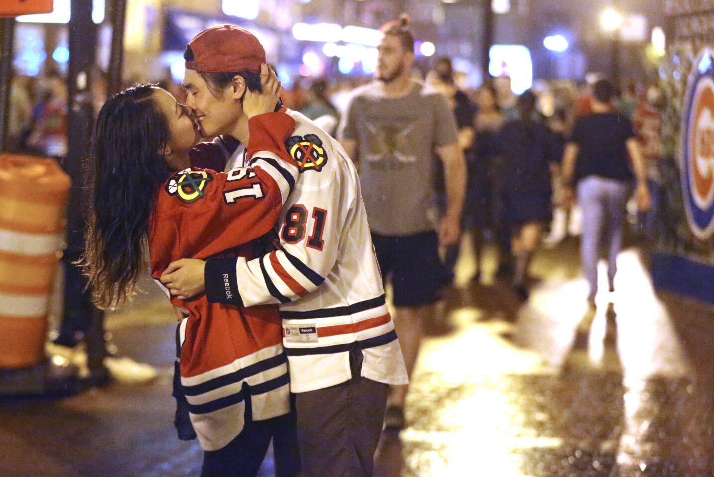 A young couple kiss at the corner of Clark and Addison streets after the Blackhawks' Stanley Cup victory June 15, 2015.