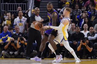 Golden State Warriors guard Donte DiVincenzo, right, defends against Los Angeles Lakers forward LeBron James