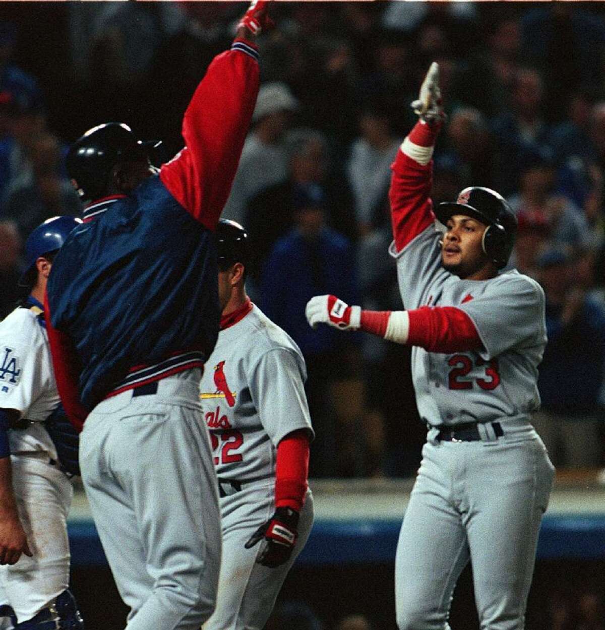 St. Louis Cardinals' Fernando Tatis, right, is greeted at home plate after hitting his second grand slam in the same inning off of DodgerS pitcher Chan Ho Park on April 23, 1999, at Dodger Stadium.