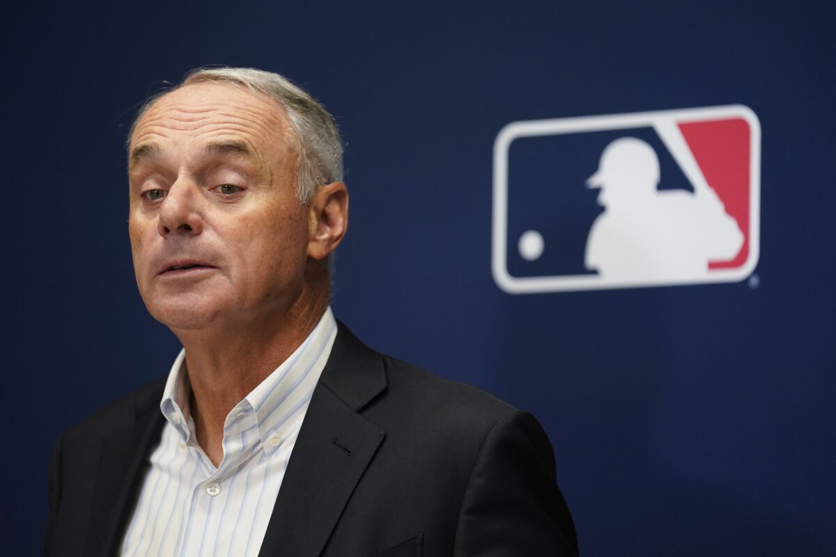 Major League Baseball Commissioner Rob Manfred speaks to reporters following an owners meeting.
