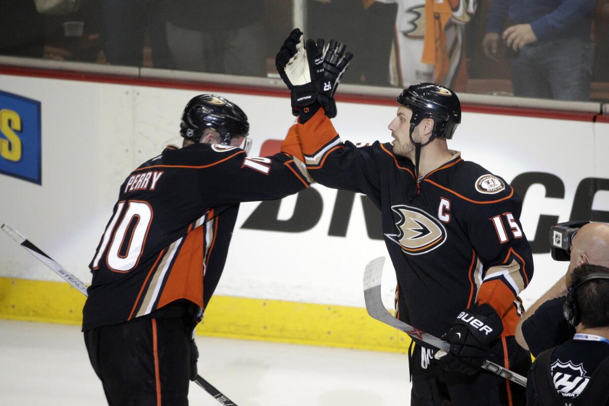 Ducks forward Corey Perry and center Ryan Getzlaf celebrate during a Ducks' playoff victory against the Flames.