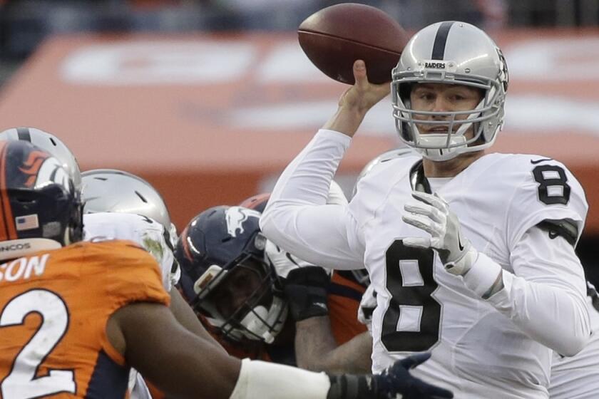 Oakland Raiders quarterback Connor Cook passes against the Denver Broncos in the first half on Sunday. The Raiders are going with the rookie quarterback in their wild-card game against the Texans on Saturday.