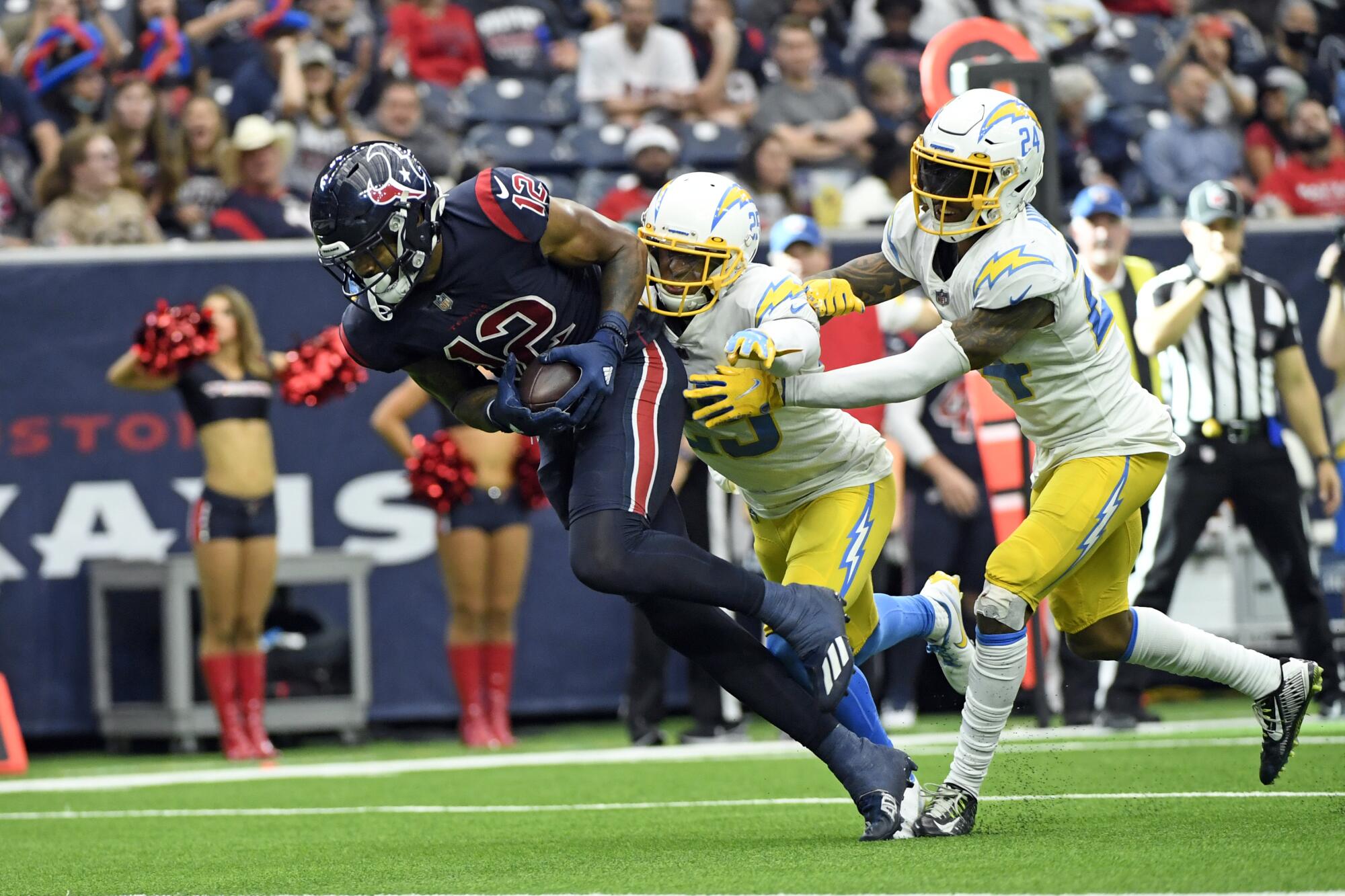 Houston Texans wide receiver Nico Collins catches a pass for a touchdown in front of Chargers defensive backs.