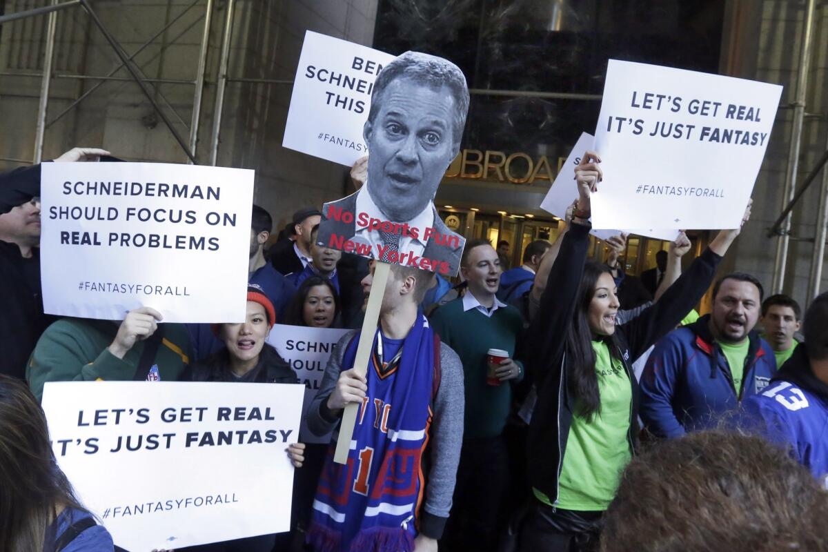 Fantasy sports fans in New York City demonstrate outside the offices of New York Atty. Gen. Eric Schneiderman in November. Schneiderman said that month that the daily fantasy sports betting sites FanDuel and DraftKings are illegal gambling operations in his state.