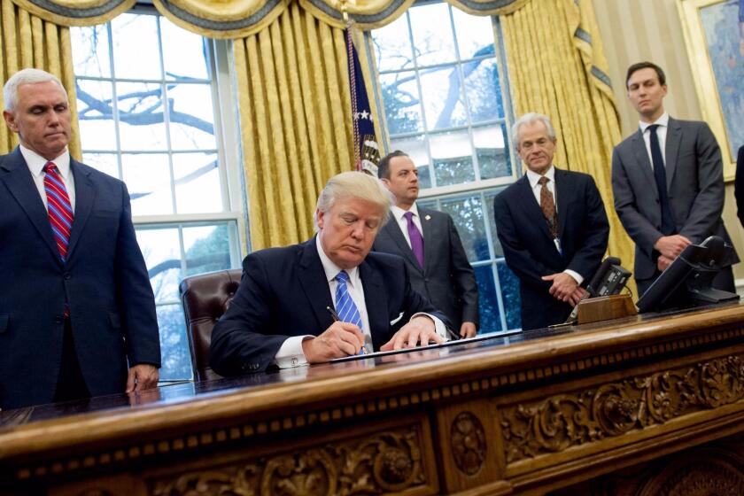 (FILES) This file photo taken on January 23, 2017 shows US President Donald Trump signing an executive order alongside White House Chief of Staff Reince Priebus (C), US Vice President Mike Pence (L), National Trade Council Advisor Peter Navarro (3rd R), Senior Advisor Jared Kushner (2nd R) and Senior Policy Advisor Stephen Miller in the Oval Office of the White House in Washington, DC, January 23, 2017. The Trump administration's top trade advisor said on March 6, 2017 US trade deficits are a threat to national security that could cause the loss of American freedom and prosperity. Outlining an unapologetically aggressive trade policy, Peter Navarro, director of the White House National Trade Council, accused economists and the media of ignoring the risk posed by trade deficits and embracing an "antiquated view of the world." / AFP PHOTO / SAUL LOEBSAUL LOEB/AFP/Getty Images ** OUTS - ELSENT, FPG, CM - OUTS * NM, PH, VA if sourced by CT, LA or MoD **