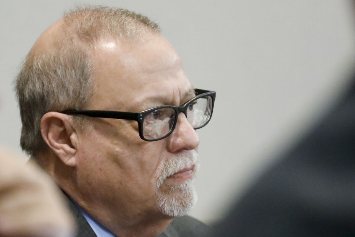 FILE - Defendant Gregory McMichael looks on during his trial along with and his son, Travis McMichael, and a neighbor, William "Roddie" Bryan, in the February 2020 slaying of 25-year-old Ahmaud Arbery, on Nov. 19, 2021, at the Glynn County Courthouse in Brunswick, Ga. Greg McMichael won’t plead guilty to a federal hate crime in the 2020 killing of the unarmed Black man, according to a legal filing late Thursday, Feb. 3, 2022. McMichael reversed his plan to plead guilty in the federal case days after a U.S. District Court judge rejected terms of a plea deal that was met with passionate objections by Arbery’s parents. (Octavio Jones/Pool Photo via AP)