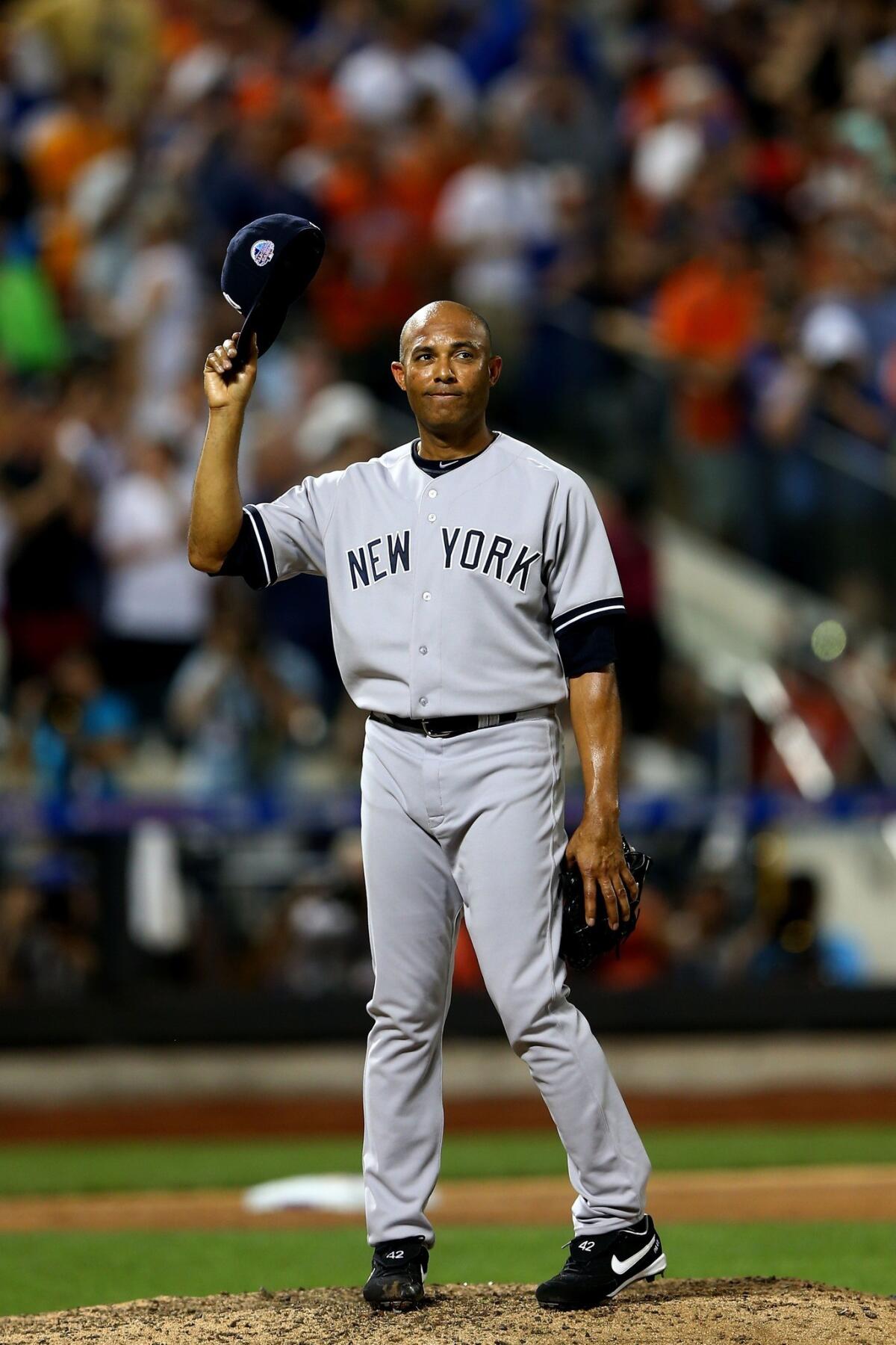 New York Yankees closer Mariano Rivera acknowledges the crowd after receiving a standing ovation during the eighth inning of American League's 3-0 victory over the National League in the MLB All-Star Game on Tuesday.