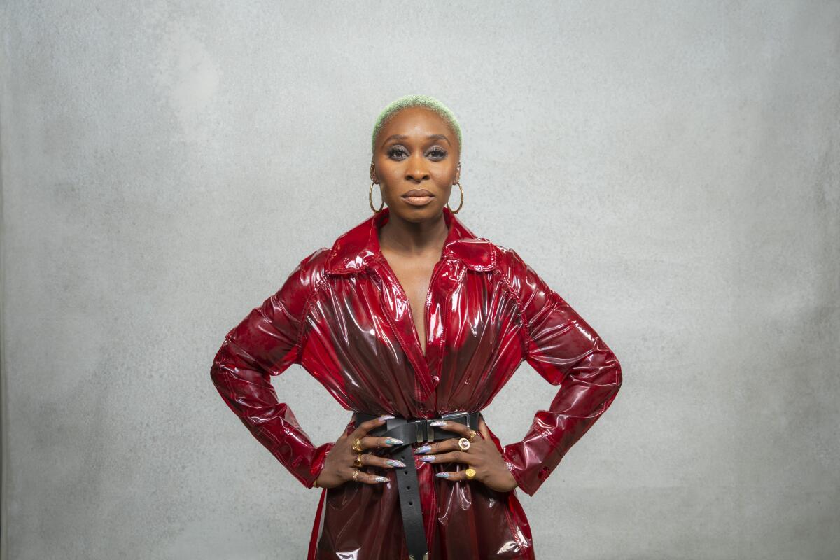 Cynthia Erivo stands with hands on her hips.