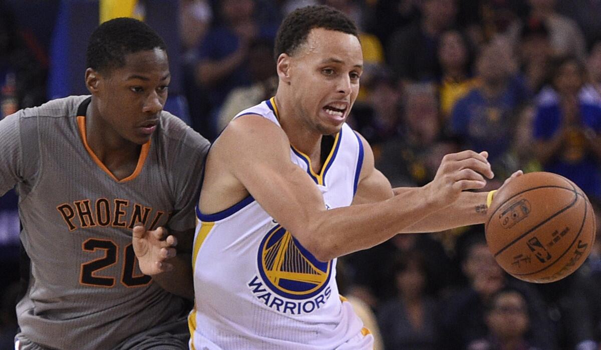 Golden State guard Stephen Curry drives the ball up the court against Phoenix guard Archie Goodwin on April 2.