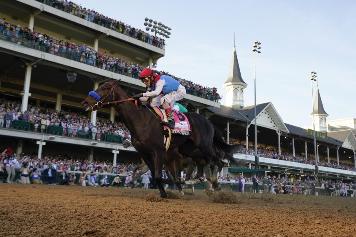 John Velazquez rides Medina Spirit across the finish line to win the 147th Kentucky Derby at Churchill Downs on May 1, 2021.