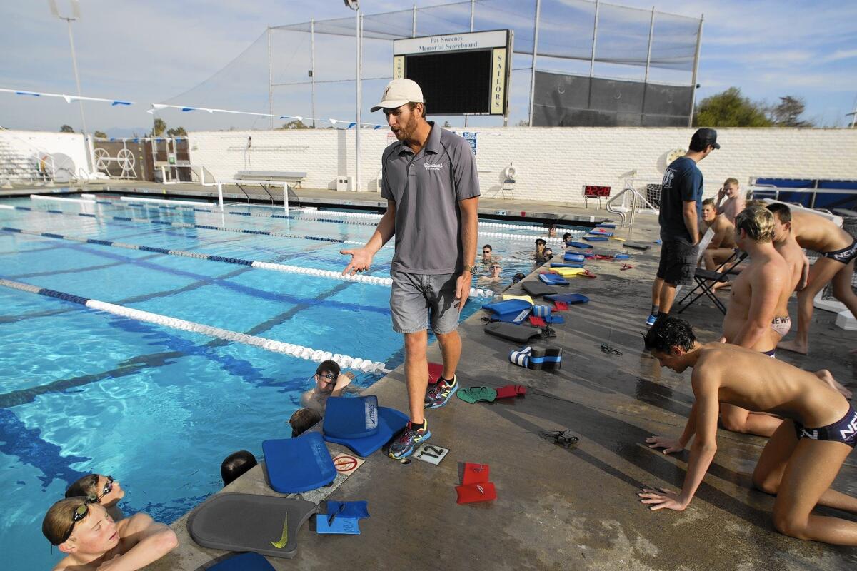 Aaron Peirsol, center, a five-time Olympic gold medalist, is the Newport Harbor High boys' swim coach.