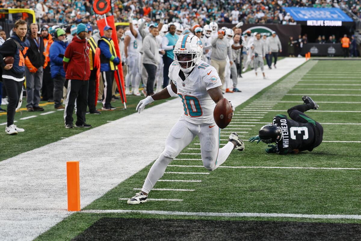 Dolphins wide receiver Tyreek Hill crosses the goal line for a touchdown.