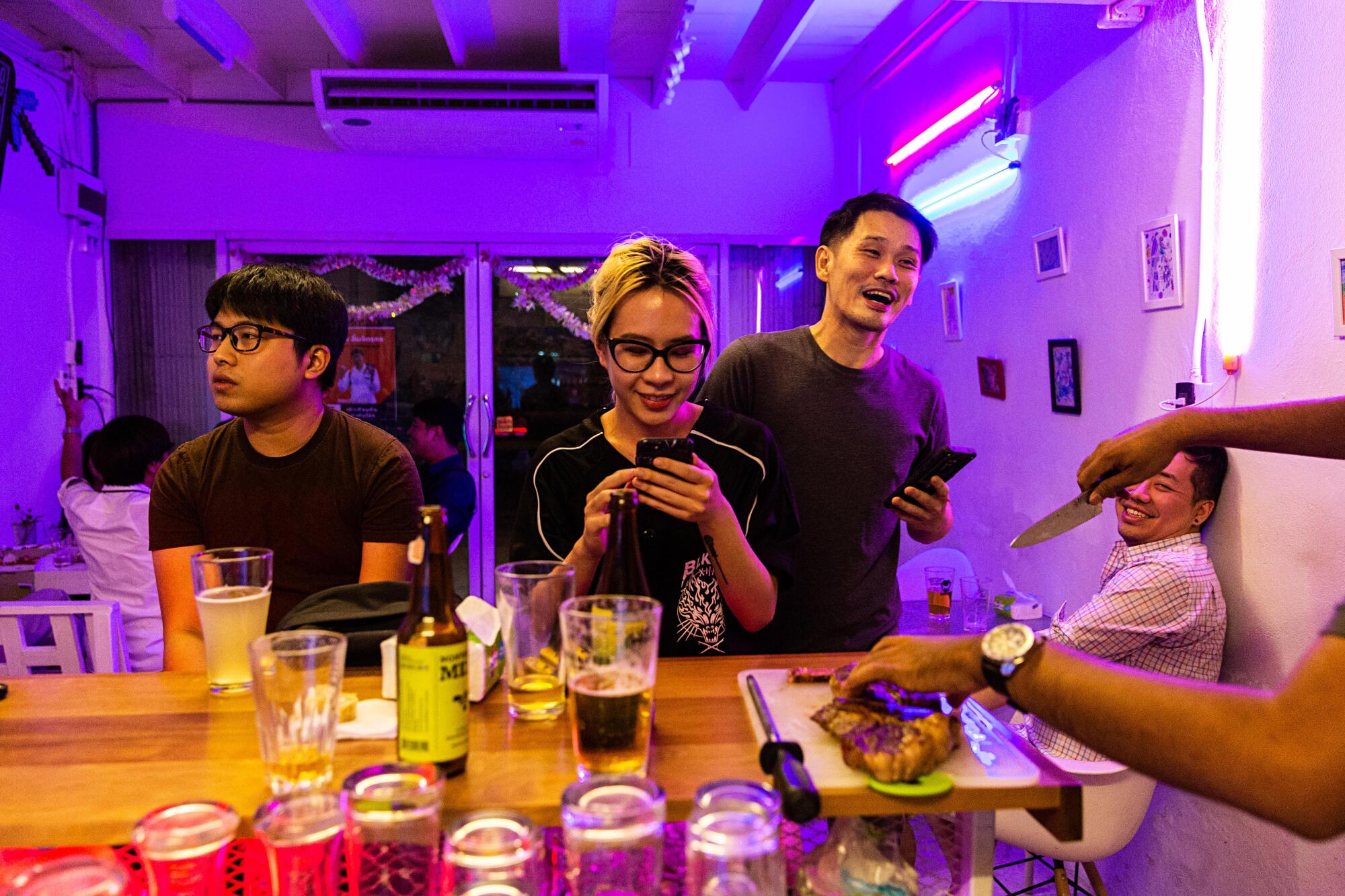 Friends gather at Taopiphop Bar Project in Bangkok, Thailand.