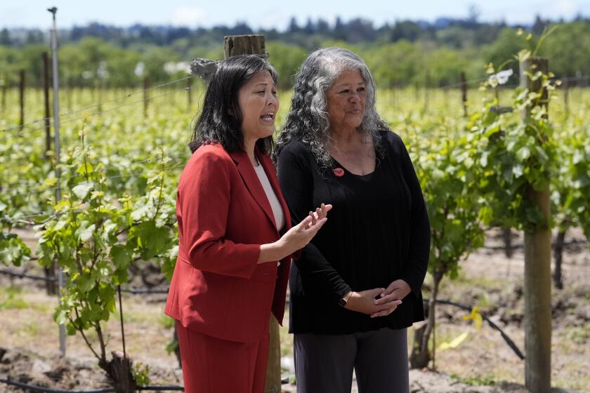 Acting United States Secretary of Labor Julie Su, left, speaks next to Teresa Romero, president of United Farm Workers, after a news conference at Balletto Vineyards in Santa Rosa, Calif., Friday, April 26, 2024. Temporary farmworkers workers are getting more legal protections against employer retaliation, unsafe working conditions, illegal recruitment and other abuses. The rule announced Friday by the Biden administration aims to bolster support workers on H-2A visas. (AP Photo/Jeff Chiu)
