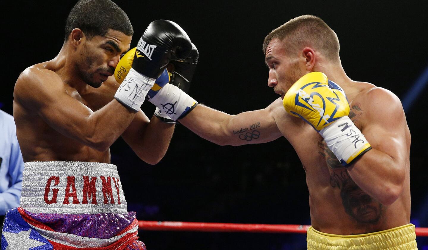 Vasyl Lomachenko lands a right to the face of Gamalier Rodriguez during their featherweight title fight on Saturday night at the MGM Grand Garden Arena.