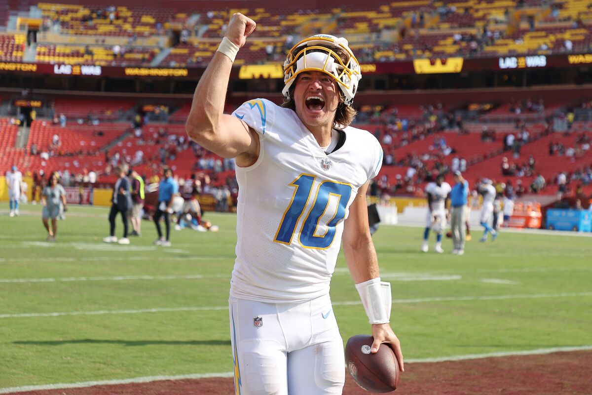 Justin Herbert of the Los Angeles Chargers celebrates after defeating the Washington Football Team on Sunday.