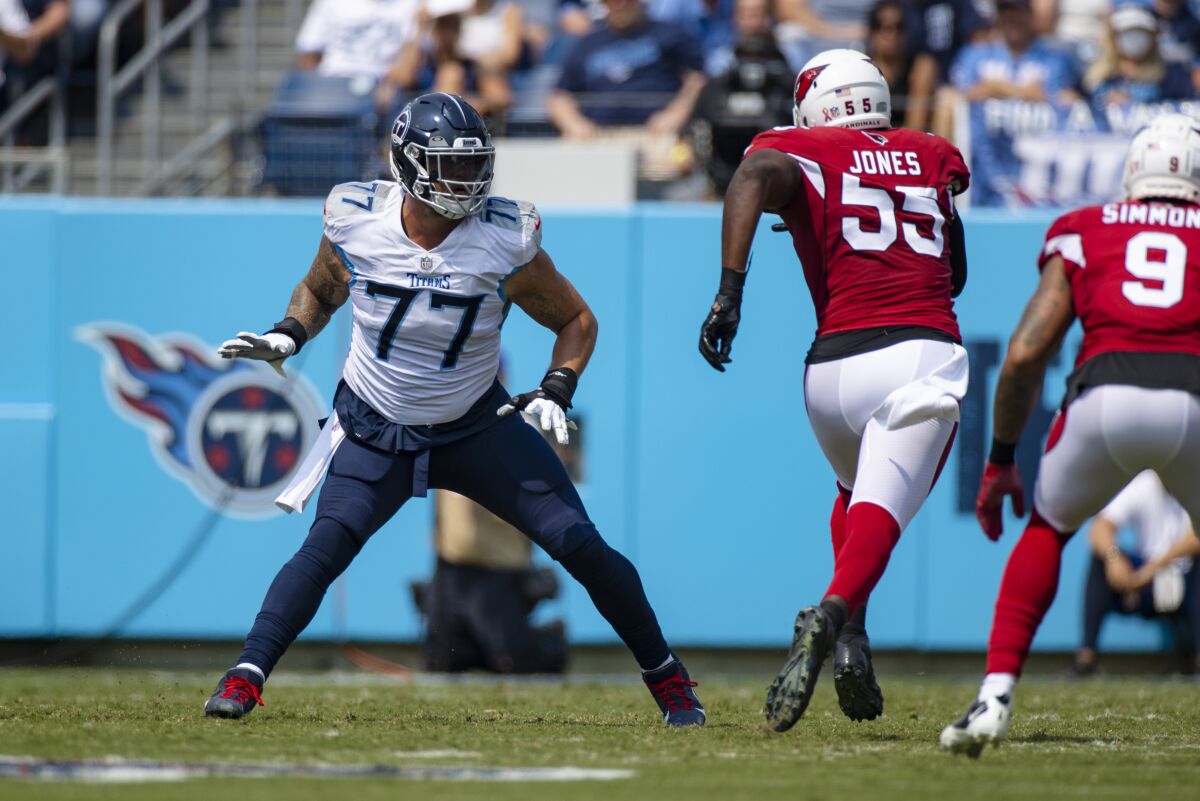 FILE - In this Sept. 12, 2021, file photo, Tennessee Titans offensive tackle Taylor Lewan (77) defends against against Arizona Cardinals linebacker Chandler Jones (55) during the first half of an NFL football game in Nashville, Tenn. Lewan says he didn't deal well with his first game back after the first injury of his career, getting so amped up the three-time Pro Bowler was drained by kickoff. That led to one of the worst performances of his career. Lewan was victimized repeatedly by Jones, who finished the game with five sacks and two forced fumbles.(AP Photo/Brett Carlsen, File)