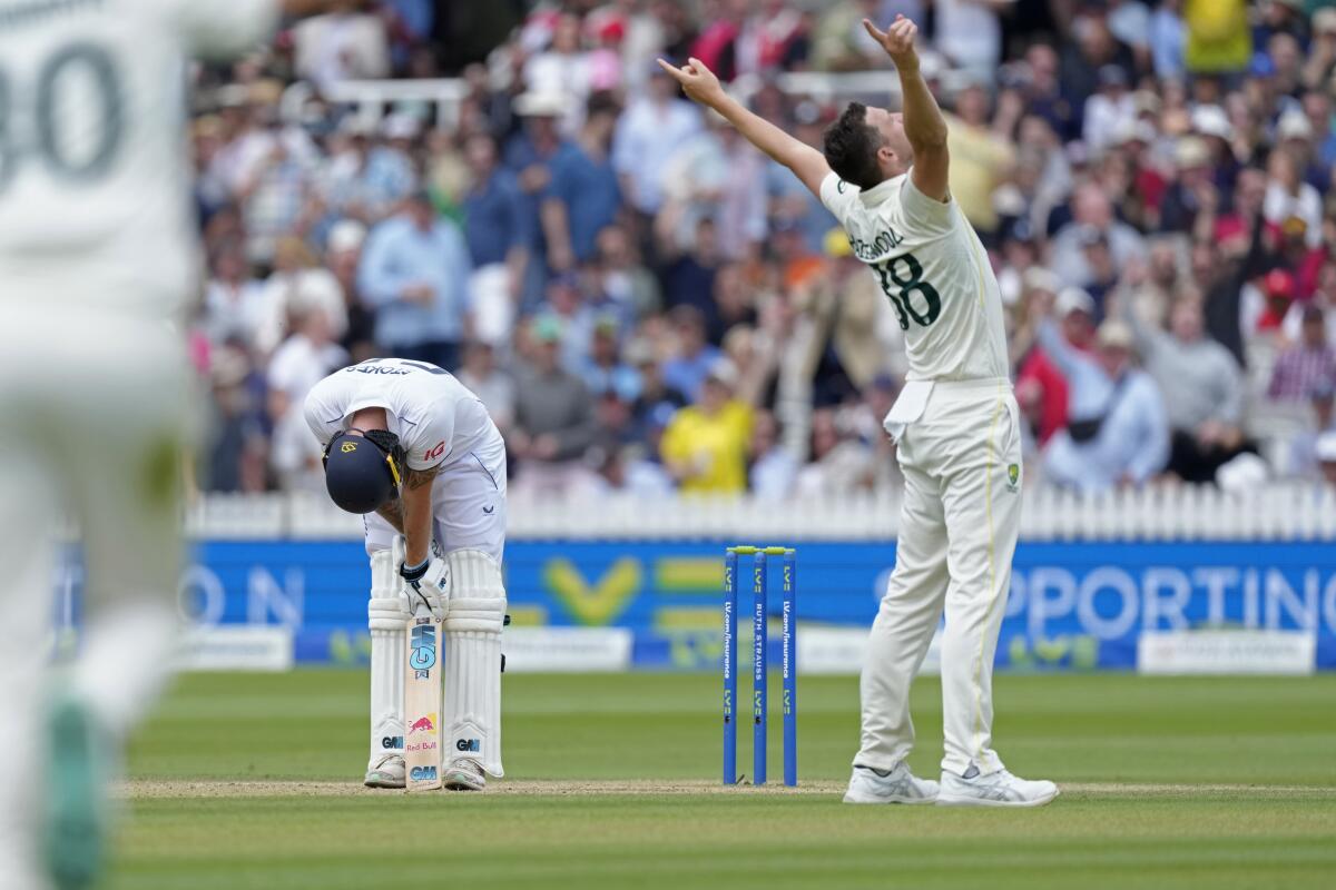 England's captain Ben Stokes, left, reacts after he is dismissed by Australia's Josh Hazlewood, right, during the fifth day of the second Ashes Test match between England and Australia, at Lord's cricket ground in London, Sunday, July 2, 2023. (AP Photo/Kirsty Wigglesworth)