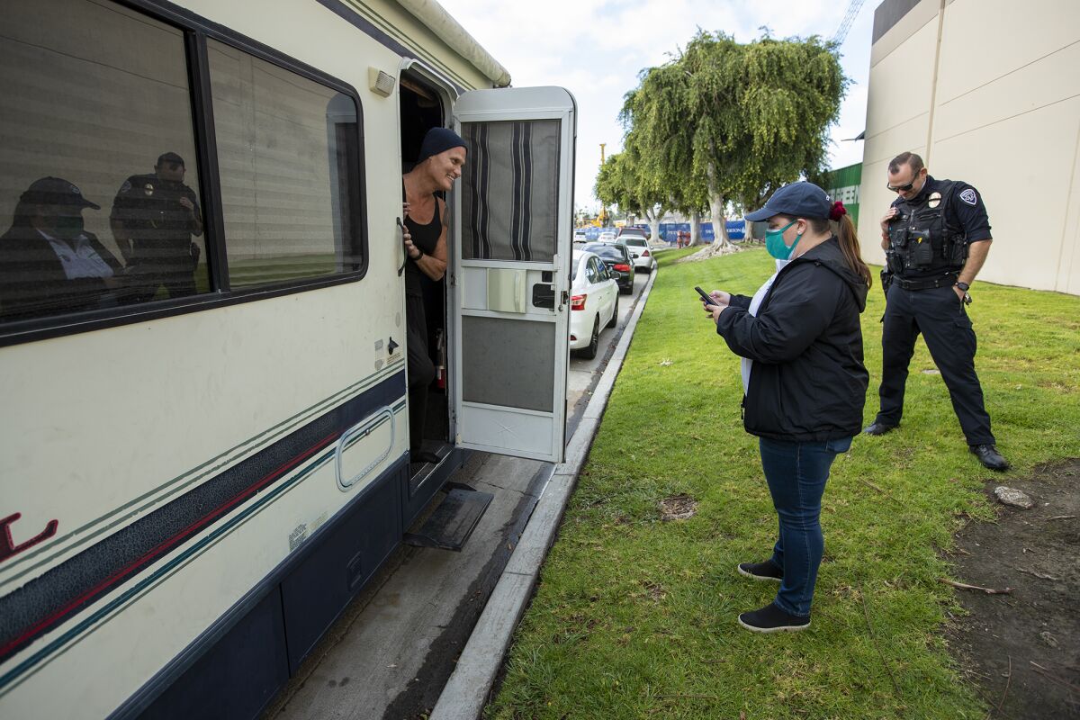 Amanda Hood and Officer Adam Hunter speak with Ron Gallego during the Point in Time count.