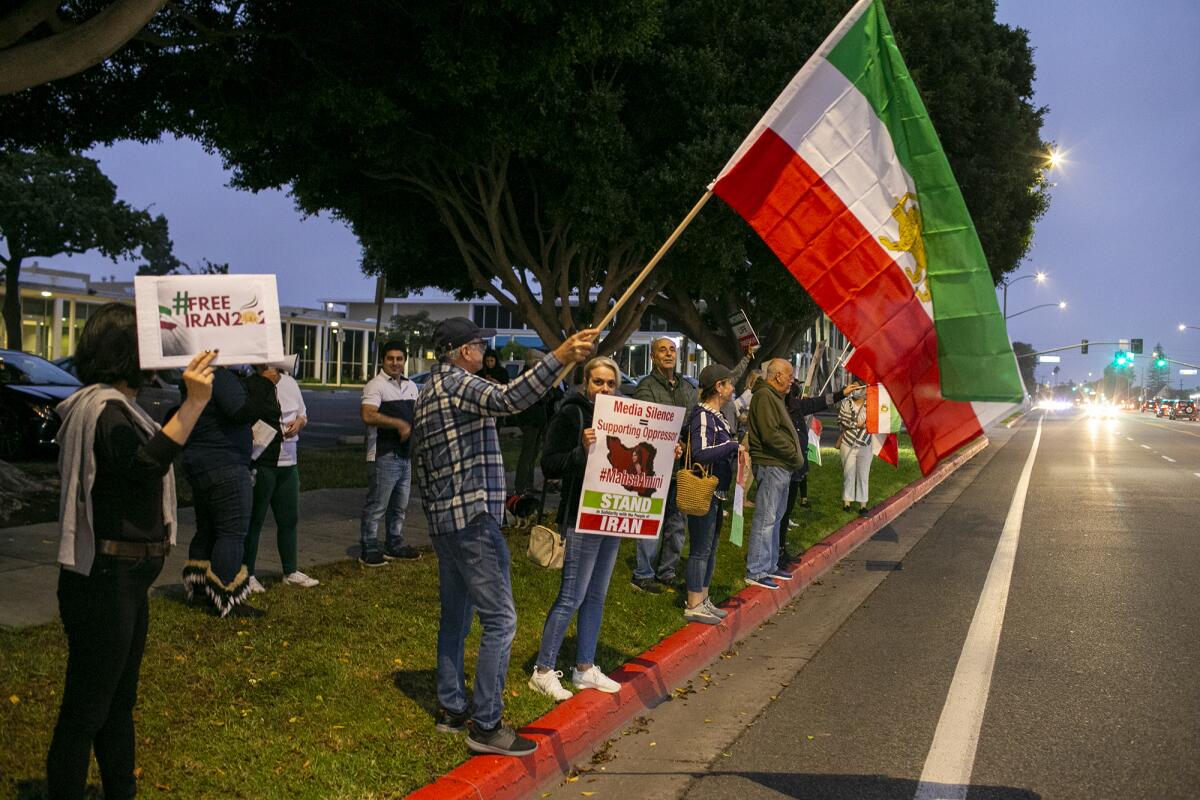 People gathered outside Costa Mesa City Hall Friday to protest crackdowns by the Islamic Republic of Iran on demonstrators. 