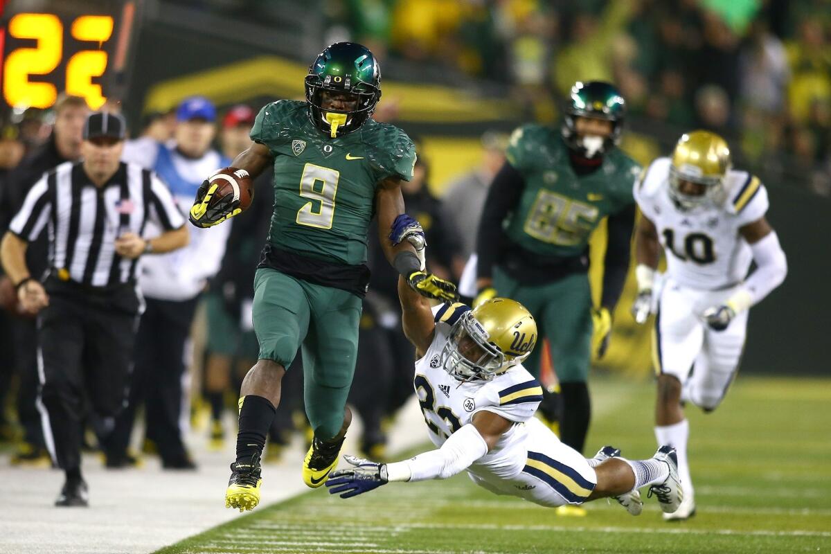 Oregon running back Byron Marshall sprints past UCLA safety Tyler Foreman during the Ducks' 42-14 win over the Bruins on Saturday.