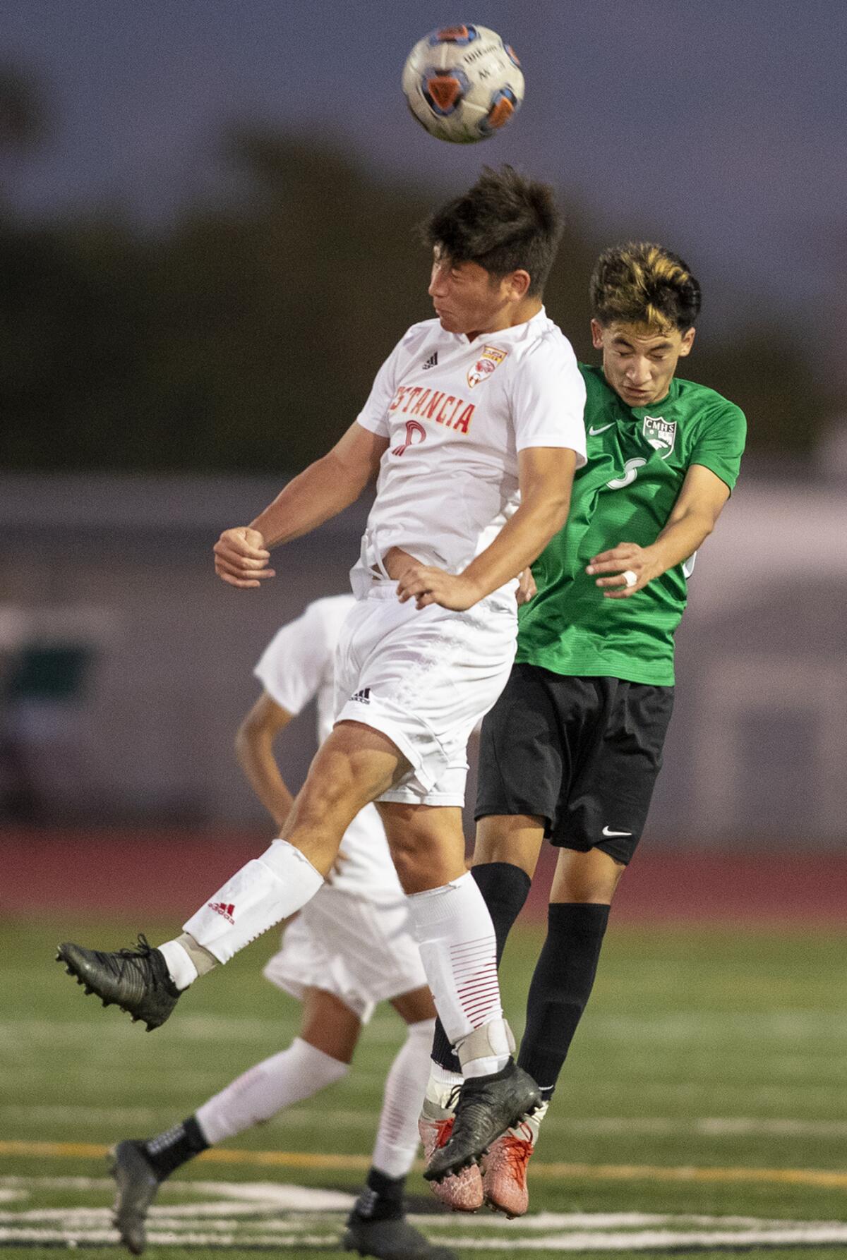 Estancia's Richard Cervantes and Costa Mesa's Isaiah Ponce go up for a header on Wednesday.