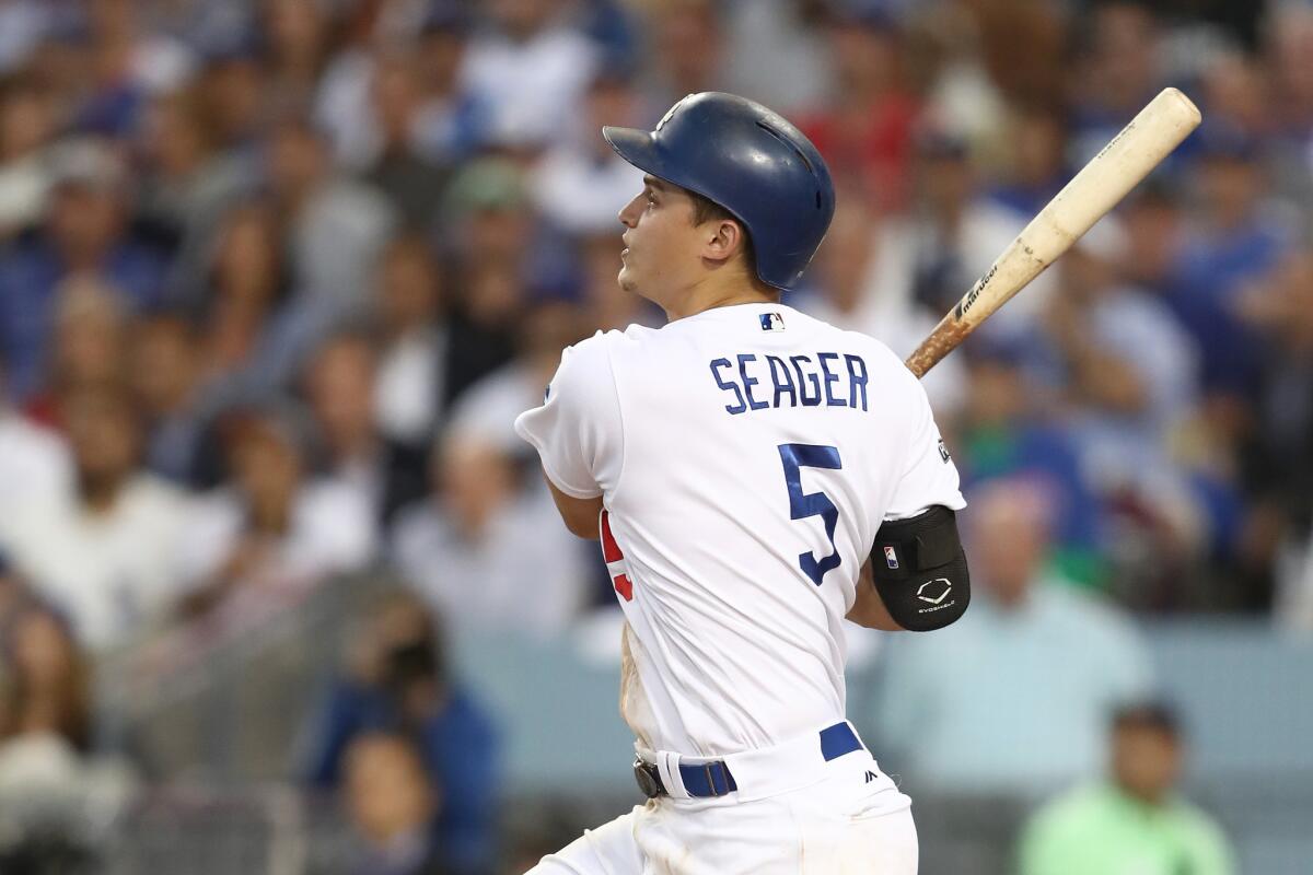 The Dodgers' Corey Seager hits an RBI single in Game 3 of the NLCS against the Chicago Cubs at Dodger Stadium on Oct. 18.