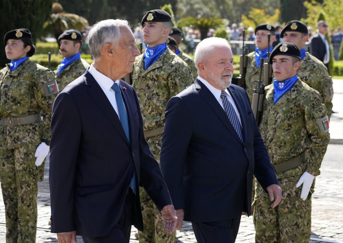 Brazilian President Luis Inacio Lula da Silva and Portuguese President Marcelo Rebelo de Sousa reviewing the troops during welcome ceremony outside the 16th century Jeronimos monastery in Lisbon, Saturday, April 22, 2023. Lula da Silva is in Lisbon for a four day state visit to Portugal. (AP Photo/Armando Franca)