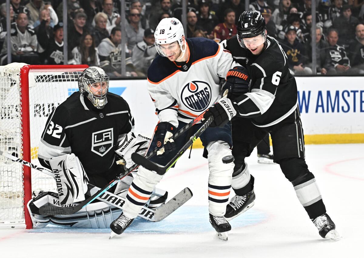 Kings' Olli Maatta defends against Edmonton Oilers' Zach Hyman as Kings goalie Jonathan Quick makes a save.