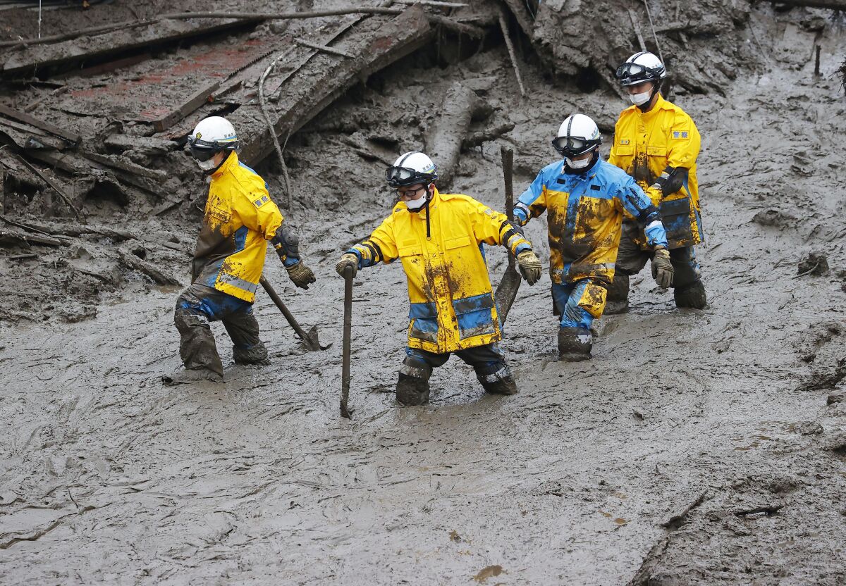 Rescue workers search the site of a mudslide in Atami, a town in Japan's Shizuoka prefecture.
