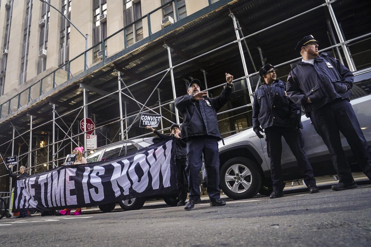 Demonstrators unveil a banner outside Manhattan's district attorney office on Thursday.