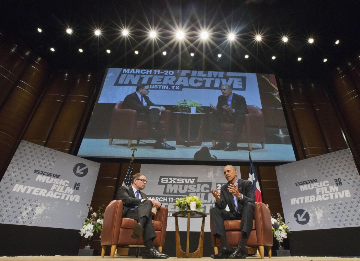Obama, right, talks with Texas Tribune Editor in Chief/CEO Evan Smith at the Center for Performing Arts in Austin.