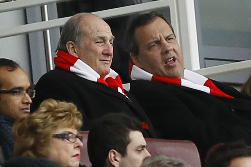New Jersey Gov. Chris Christie and Rutgers University President Robert Barchi watch a Feb. 1 soccer match in London, where the governor is visiting for a trade mission.