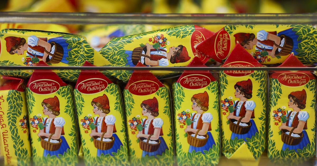 Bulk waste bucket overcrowded with the chocolates of chocolates on the Russian market Odessa