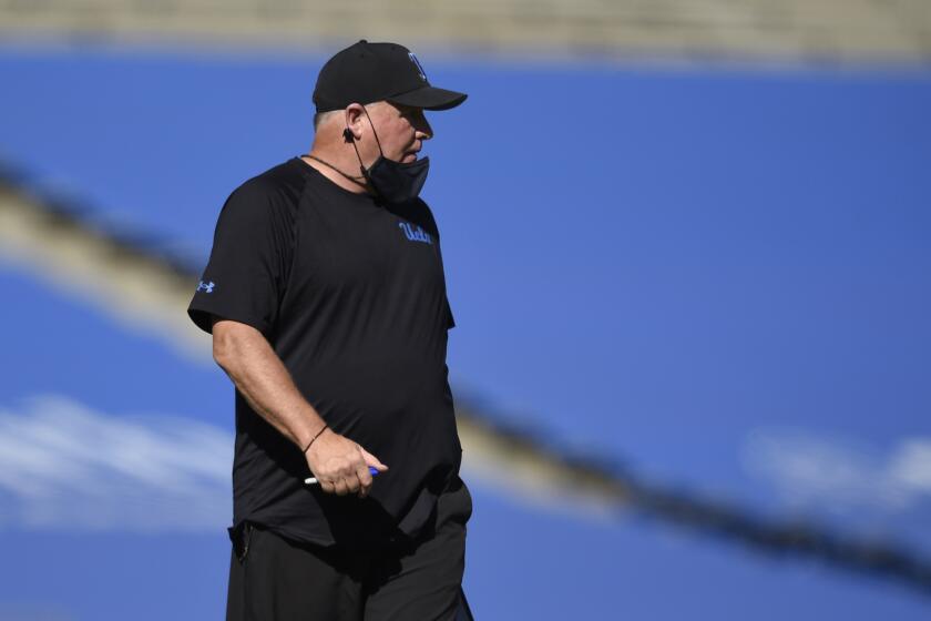 UCLA head coach Chip Kelly walks along the sidelines during the second half of an NCAA college football game against California in Los Angeles, Sunday, Nov. 15, 2020. UCLA won 34-10. (AP Photo/Kelvin Kuo)