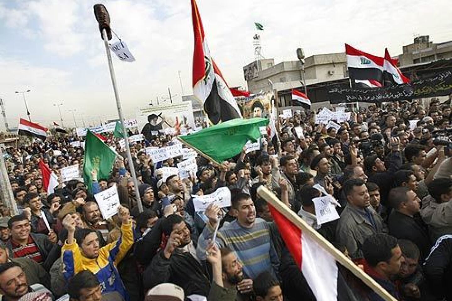 Iraqis in Baghdad's Sadr City district protest the recent visit by President Bush and the arrest of Iraqi journalist Muntather Zaidi, who caused a furor when he hurled shoes at Bush during a news conference with Iraqi Prime Minister Nouri Maliki.