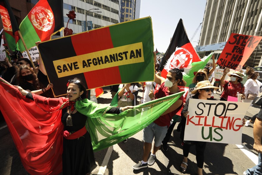 Protesters hold signs during a march.