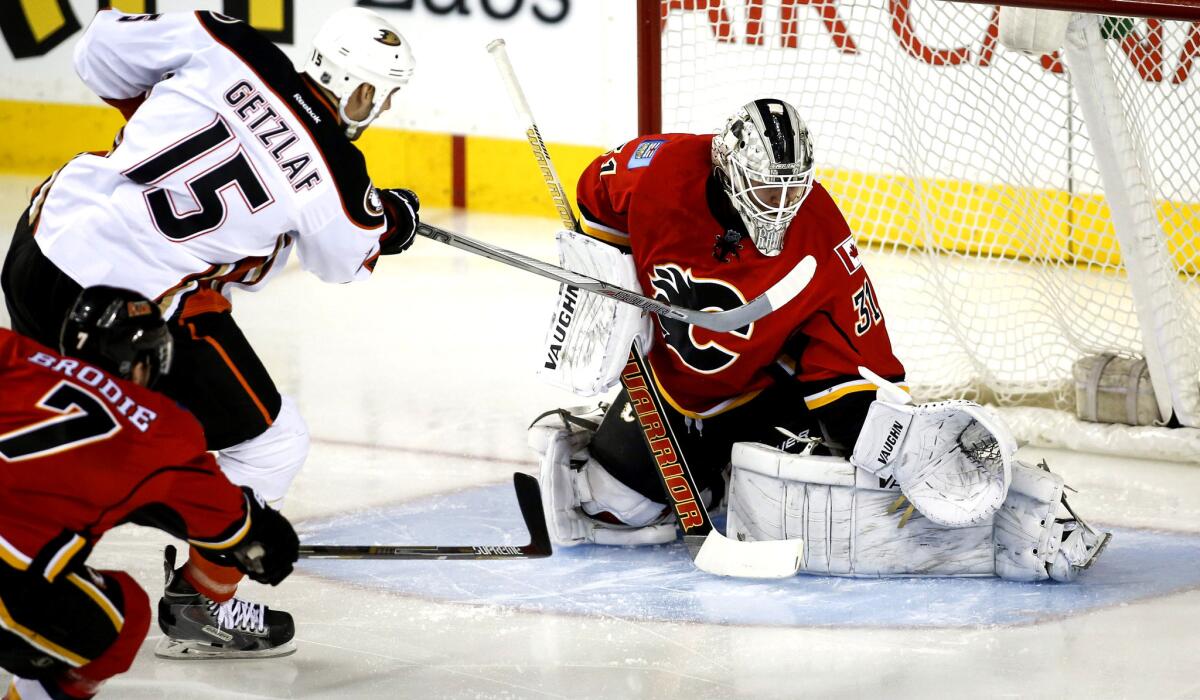 Ducks center Ryan Getzlaf (15) scores against Flames goalie Karri Ramo during the first period of a game on March 11.