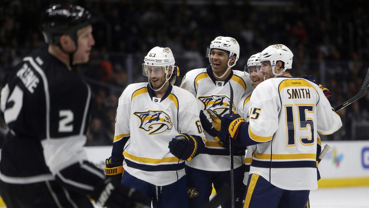 Nashville Predators defenseman Ryan Ellis, second right, celebrates with his teammates after scoring during the first period of a 7-6 overtime win over the Kings at Staples Center on Saturday.