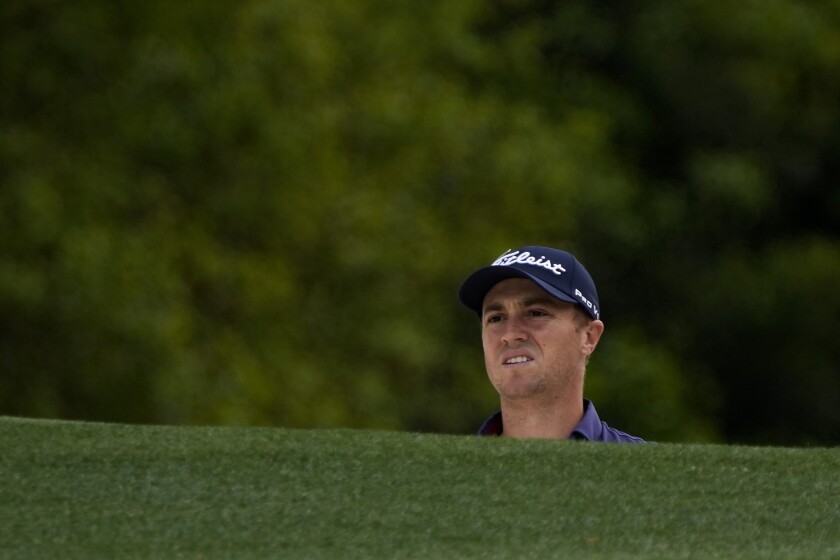 FILE - Justin Thomas watches his shot on the first hole during the final round of the Masters golf tournament on Sunday, April 11, 2021, in Augusta, Ga. The bunker is so deep that players can't always see the putting surface. (AP Photo/David J. Phillip, File)