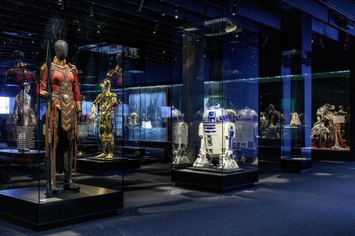Academy Museum of Motion Pictures exhibit displaying characters from "Black Panther," "Star Wars," and "Dark Crystal."