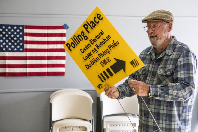 San Diego, CA - November 04: Richard Westfall, of San Diego, sets up polling place signs at the Islamic Center of San Diego on Friday, Nov. 4, 2022 in San Diego, CA. Election officials are preparing to open 218 voting centers in the county on Saturday. Poll workers have been trained in de-escalation techniques in case any problems arise with poll watchers, etc.(Meg McLaughlin / The San Diego Union-Tribune)