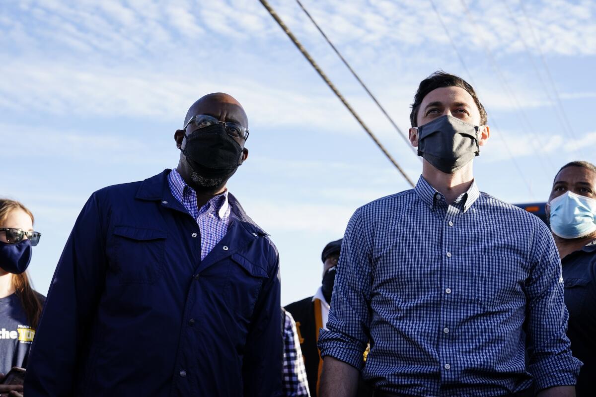 Georgia  candidates for  Senate Raphael Warnock, left, and Jon Ossoff at a Nov. 15 rally