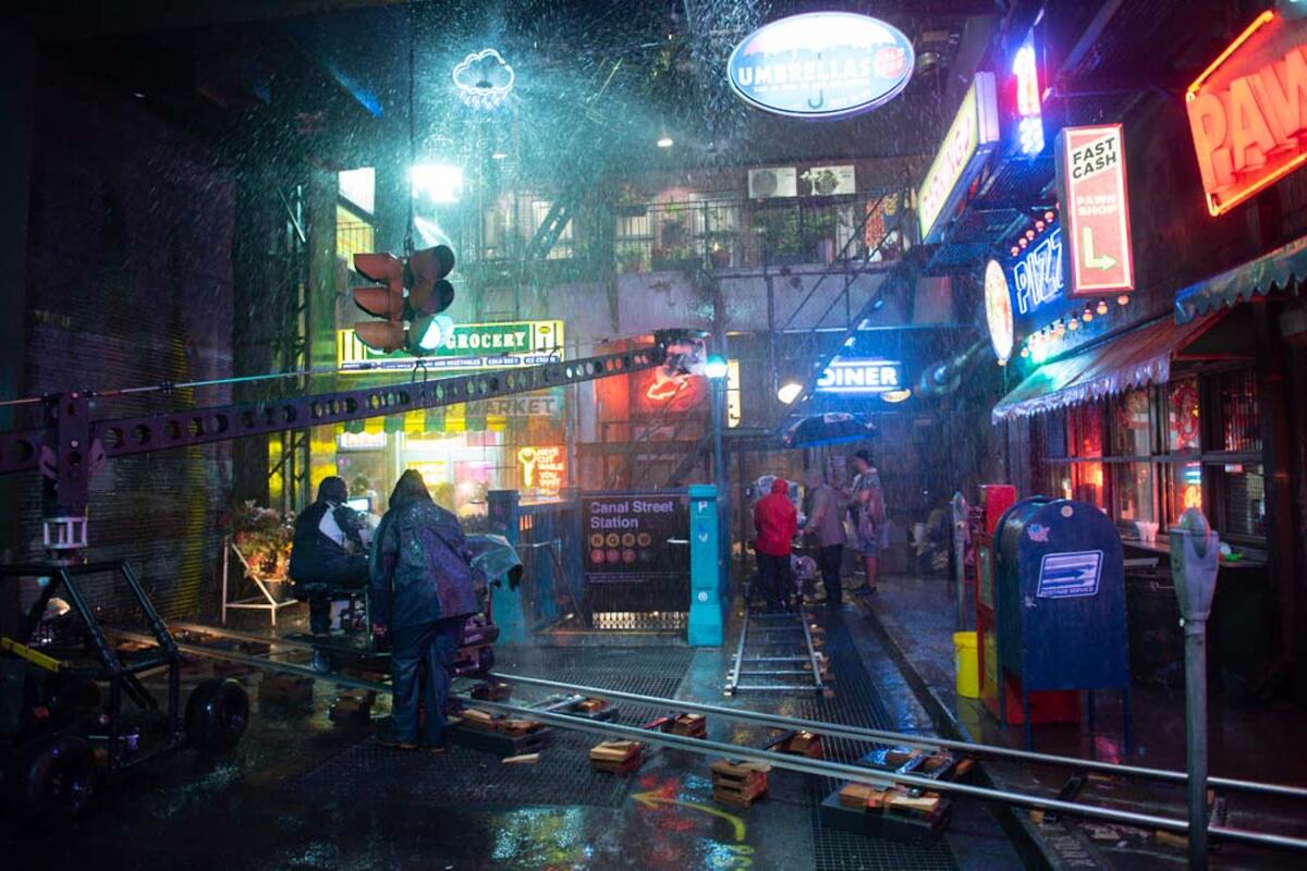 Fake rain falls on a New York City film set 