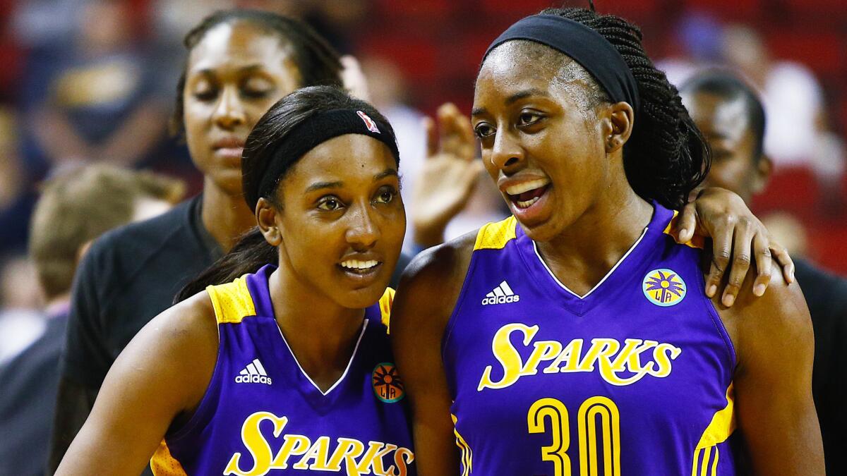 Sparks teammates Candice Wiggins and Nneka Ogwumike celebrate after Saturday's win over the Seattle Storm.
