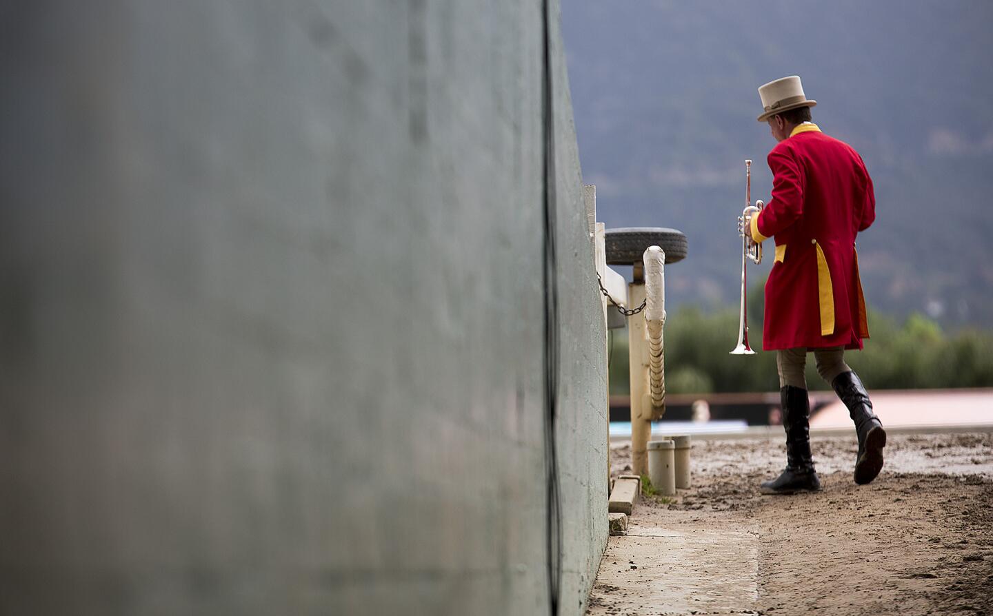 Track bugler Jay Cohen walks out to play at Santa Anita Park on April 9, 2016, the day of the Santa Anita Derby.